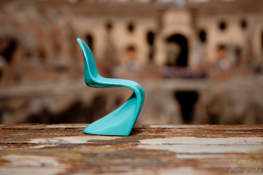 Miniature blue Panton chair in the Coliseum, Rome, Italy